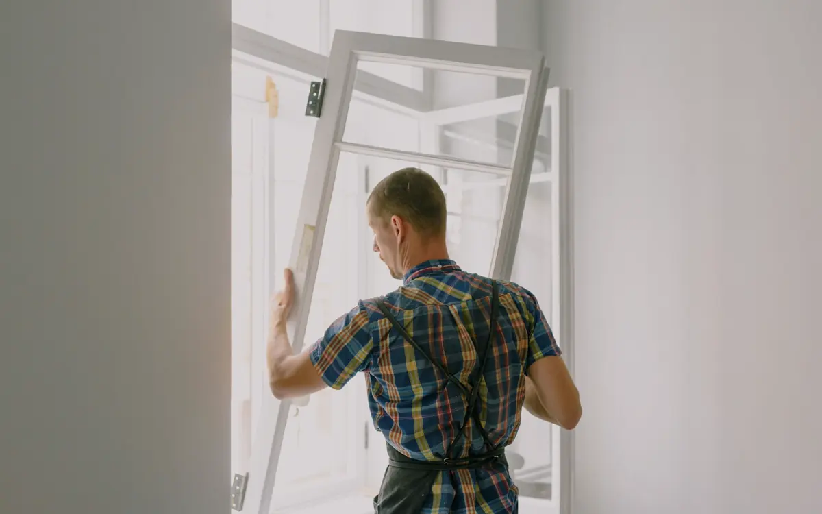 Professional installing a window during a home renovation